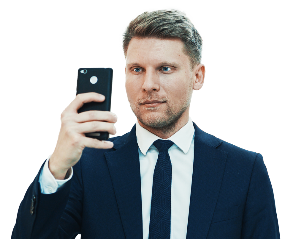 A neat looking man wearing formal coat and doing a mirror selfie.