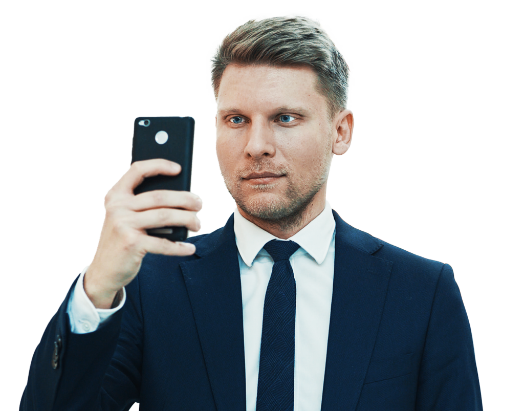 A neat looking man wearing formal coat and doing a mirror selfie.